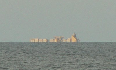 A cargo ship clearly over the horizon